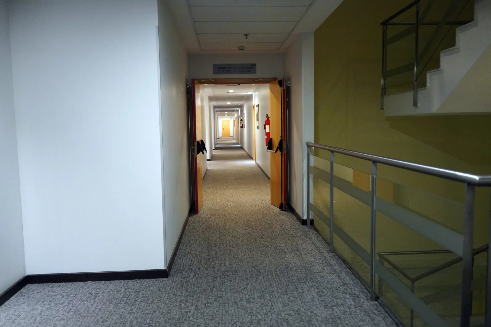 Long hallway with wall-to-wall low-pile carpet