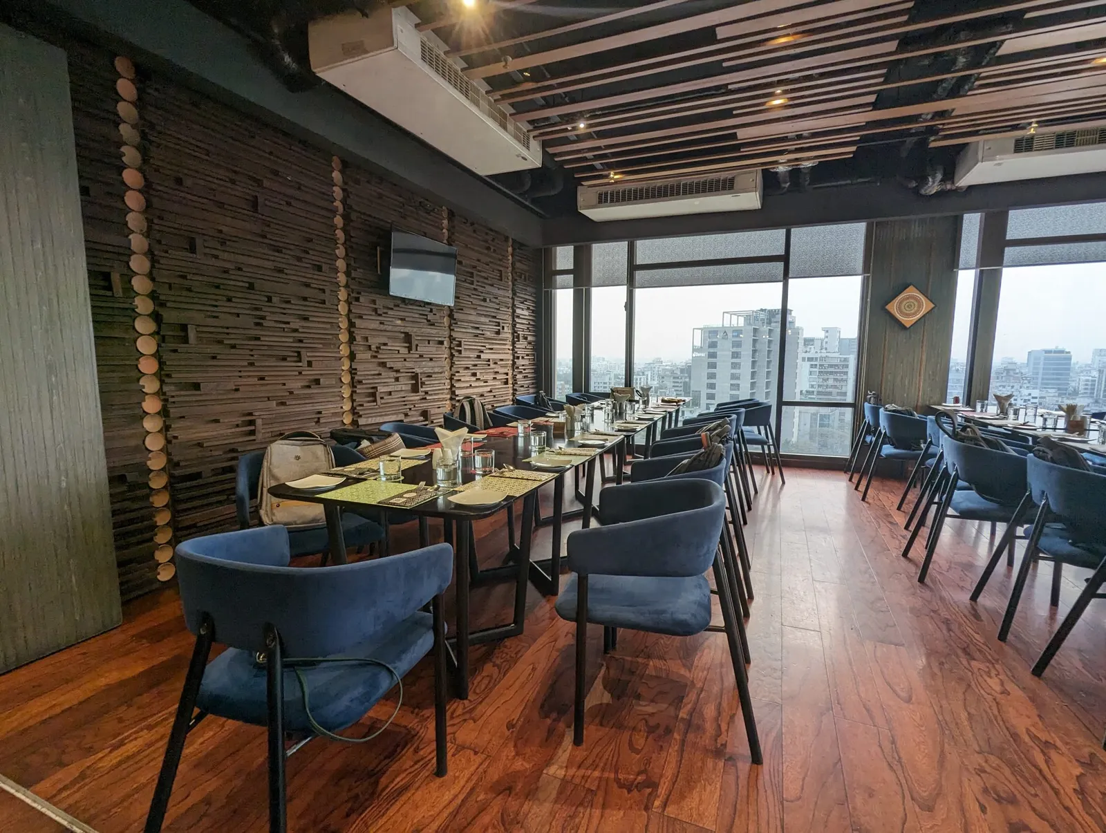 Restaurant dining room with tables and chairs on a hardwood floor