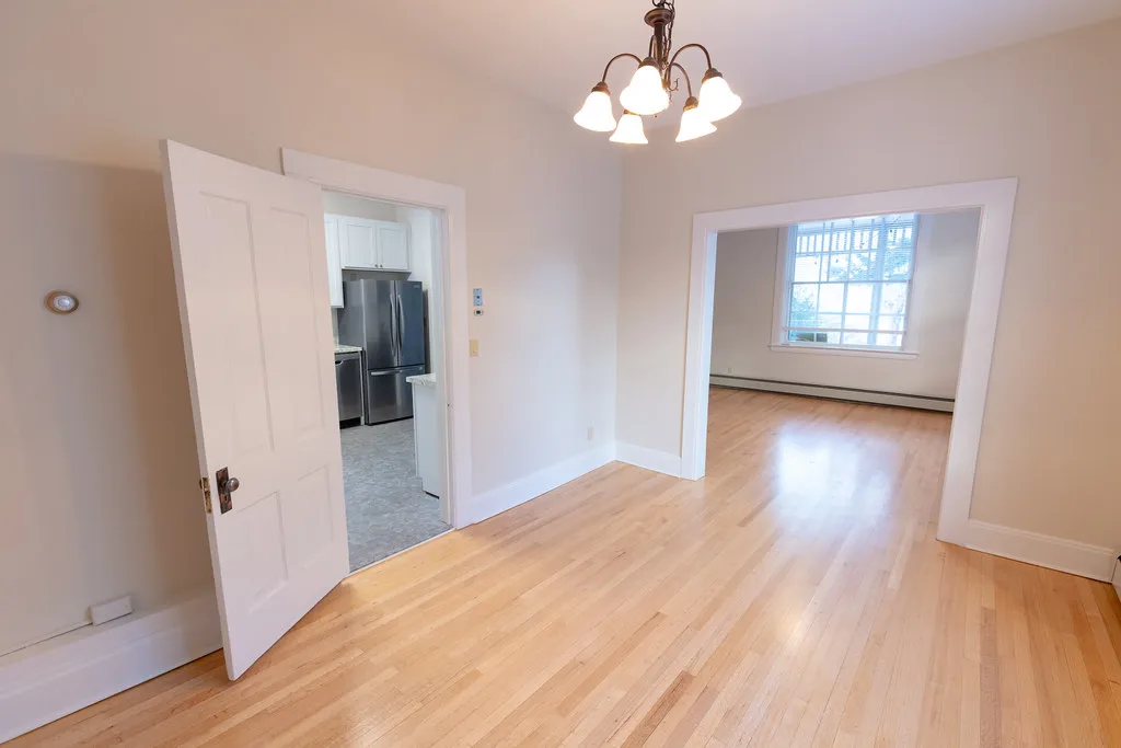 Freshly finished hardwood floor in an empty dining room