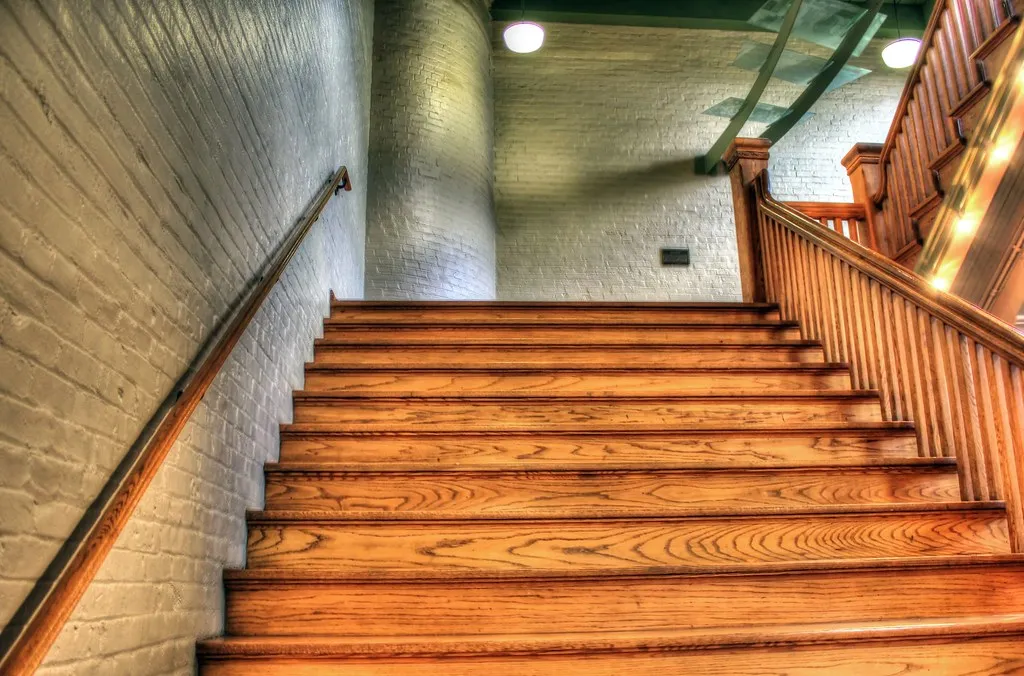 Oak stair treads and wood railing on an interior staircase